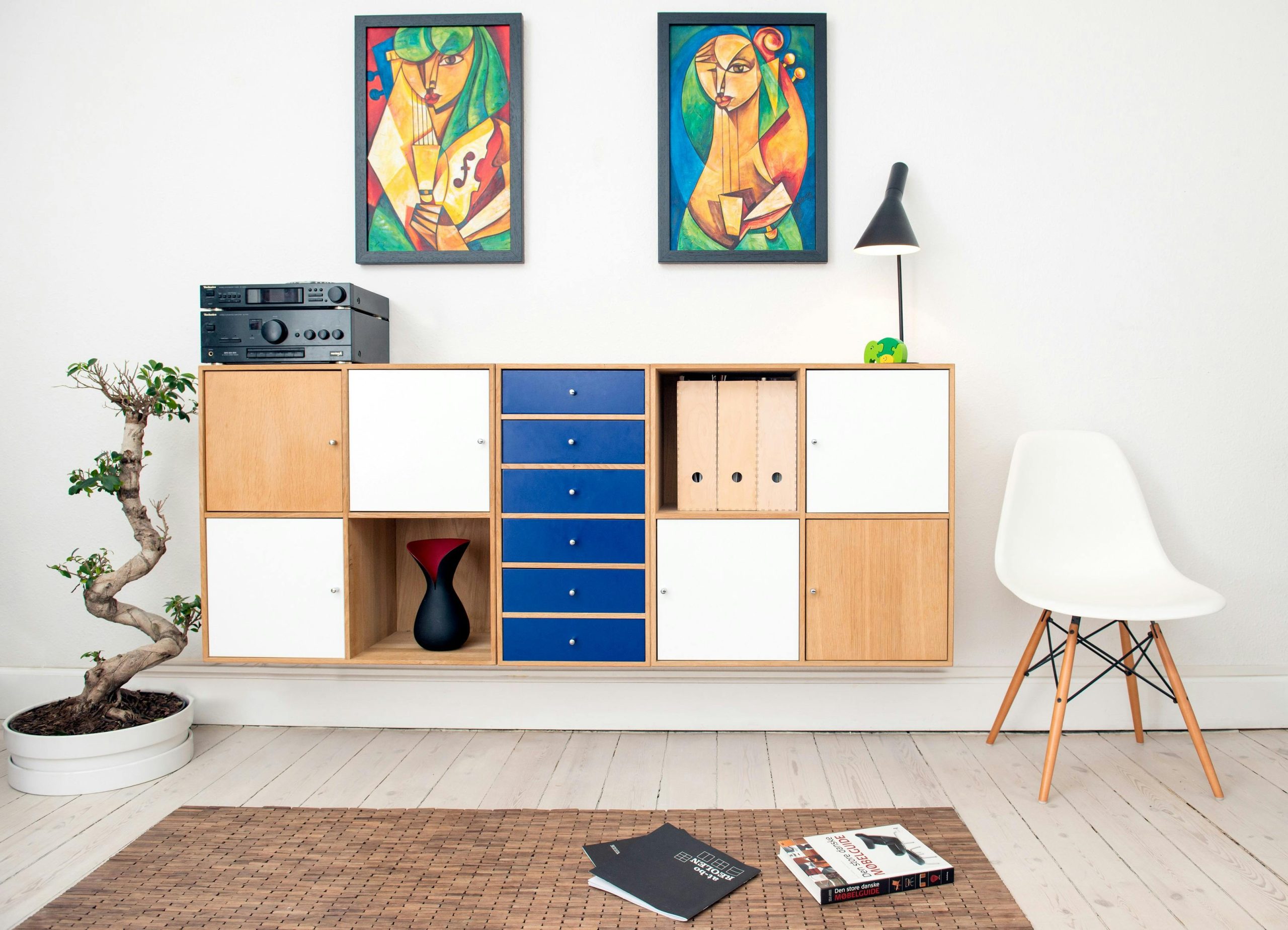 colorful shelf design with two paintings above